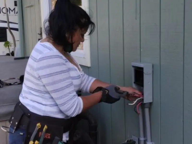 Licensed electrician wiring an exterior subpanel in Newton