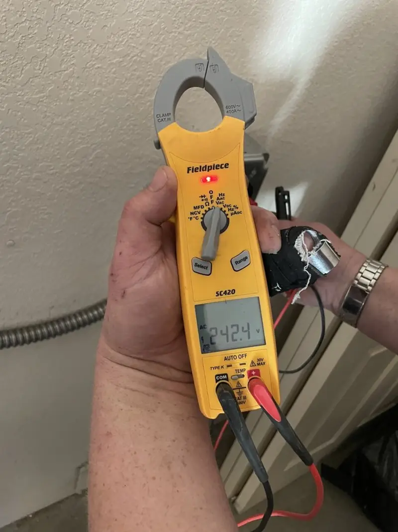 Voltage testing with clamp meter during Electrical Installation Services in Newton